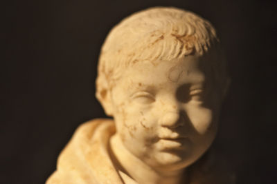 Close-up of statue against black background