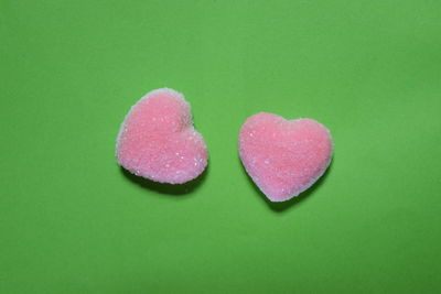Close-up of heart shape on pink over white background