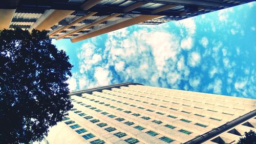 Low angle view of building against cloudy sky