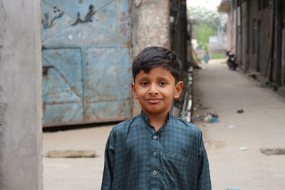 Portrait of child standing in city