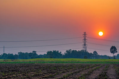 Scenic view of field against sky during sunset