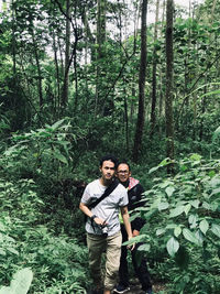 Portrait of young man standing in forest