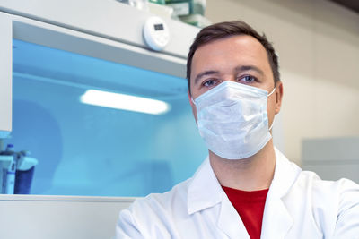 Close-up of female scientist examining chemical in laboratory