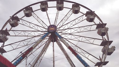 Low angle view of ferris wheel against sky