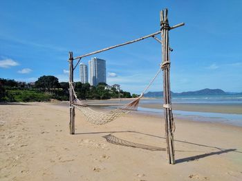 Lifeguard hut on beach against blue sky