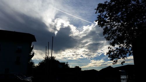 Low angle view of buildings against cloudy sky