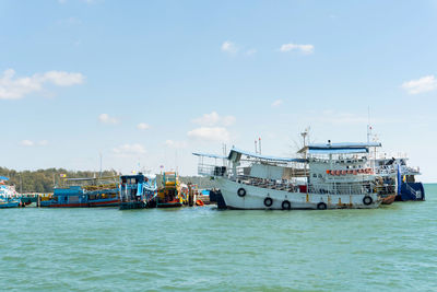 Ship moored at harbor against sky