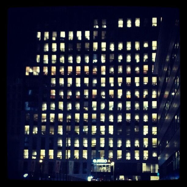 LOW ANGLE VIEW OF MODERN BUILDING AT NIGHT