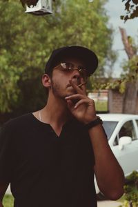 Portrait of young man smoking cigarette