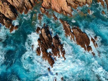 Aerial view of rock formations in sea