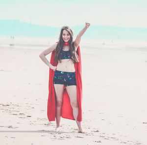 Portrait of young woman standing on beach