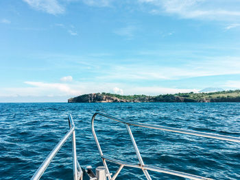 Sailboat sailing in sea against blue sky