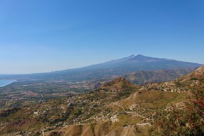 Scenic view of mountains against clear blue sky