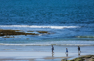 People on beach by sea