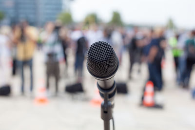 Close-up of microphone against crowd