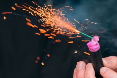 Person holding firework display at night