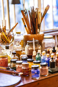 Close-up of paintbrushes in jar on table