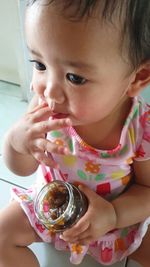 Close-up portrait of cute girl holding ice cream