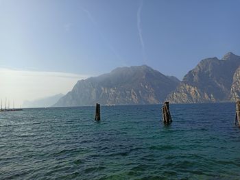 Scenic view of sea and mountains against sky