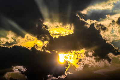 Low angle view of fire against sky during sunset