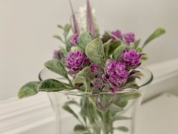 Close-up of purple flower vase on table