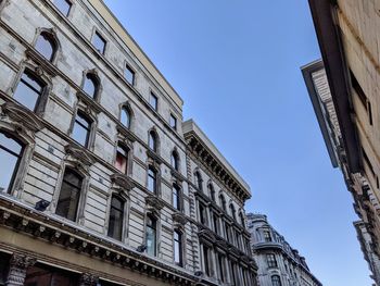 Low angle view of buildings against clear blue sky