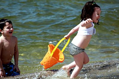 Full length of shirtless boy in water