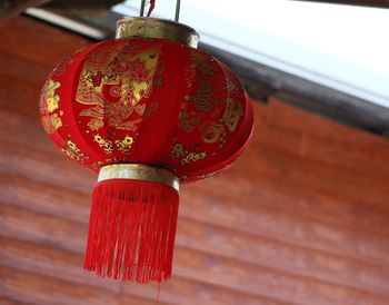 Low angle view of lanterns hanging on wood