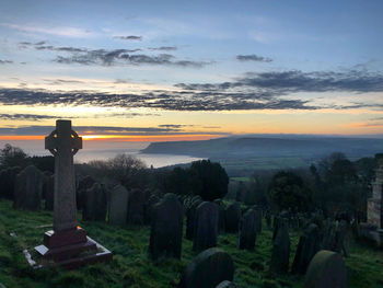 Scenic view of cemetery against sky during sunset