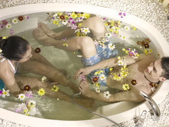 High angle view of couple relaxing in bathtub