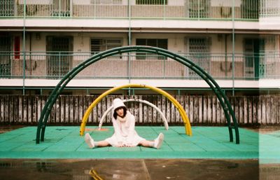 Woman sitting in front of building