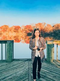 Portrait of woman standing against clear sky