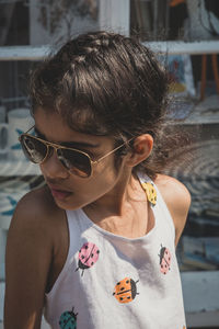 Portrait of girl wearing sunglasses standing outdoors