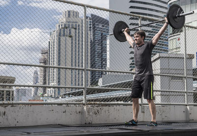 Man training at rooftop gym in bangkok