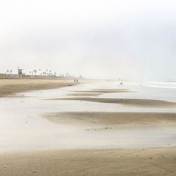 Scenic view of beach against sky during winter