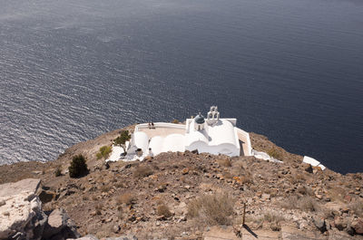 High angle view of church on cliff by sea