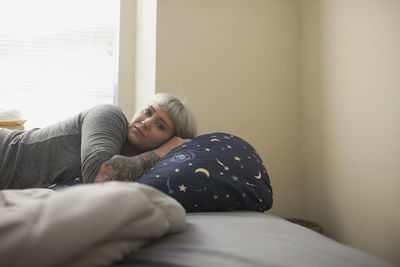 Young woman lying in bed