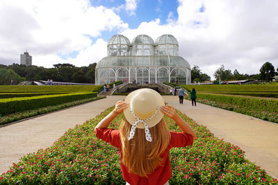 Rear view of fashion traveler girl in botanical garden of curitiba, parana, brazil.