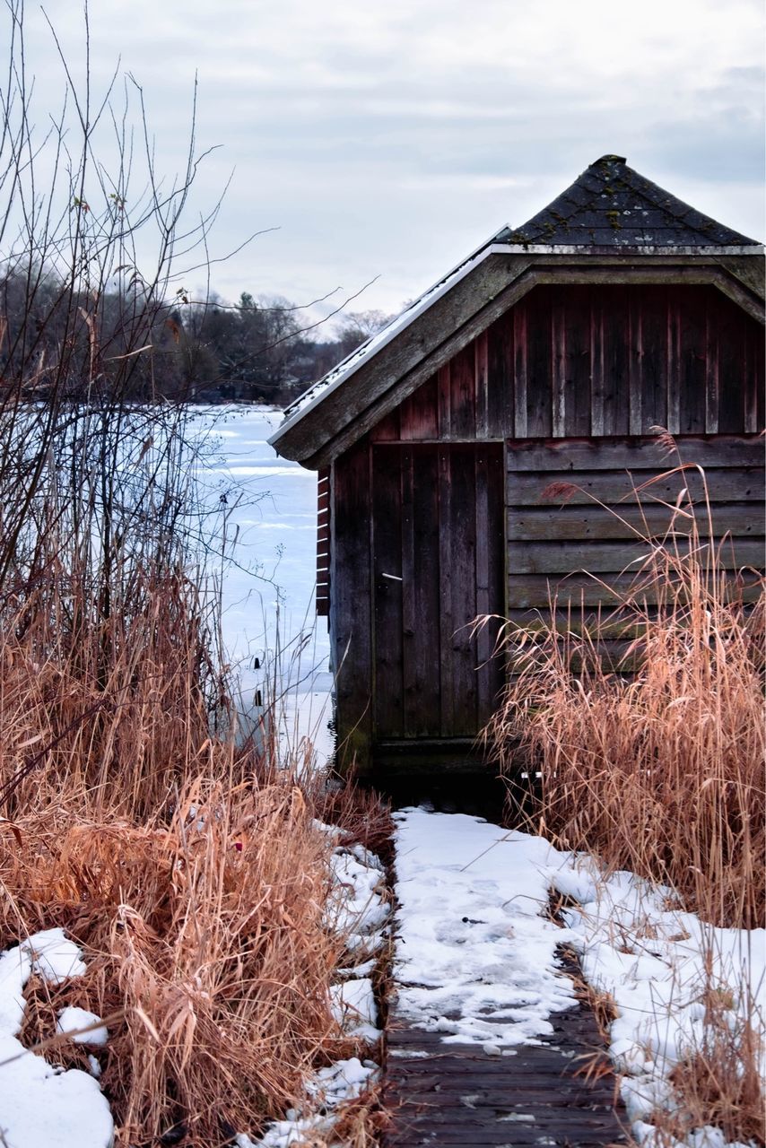 winter, architecture, built structure, snow, nature, cold temperature, building exterior, rural area, wood, sky, plant, landscape, water, building, house, cloud, no people, shack, tree, environment, non-urban scene, scenics - nature, rural scene, day, beauty in nature, reflection, outdoors, land, bare tree, tranquility, barn, lake, frozen, agricultural building, autumn, hut, residential district, home