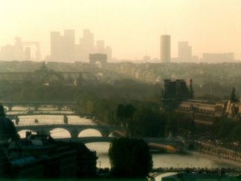 High angle view of bridge over river by buildings in city