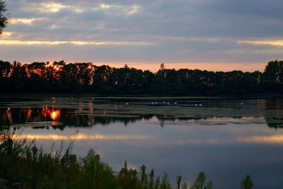 Scenic view of lake against sky at sunset