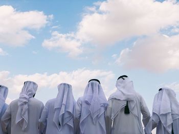 Arabic men from behind in kandora /thawb- traditional dress. 
