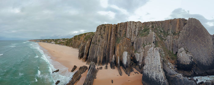 Aerial view of waves on a beautiful sandy ocean beach and cliff. panorama atlantic coastline.