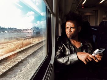 View of man sitting in train