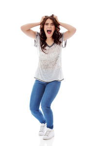 Portrait of beautiful young woman against white background