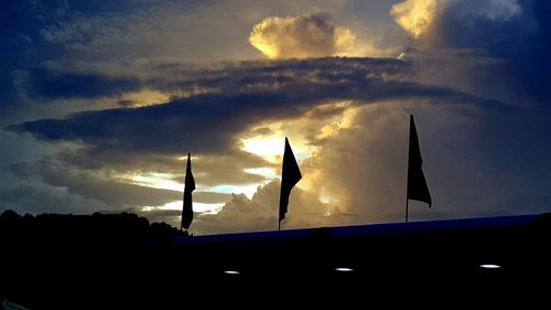 Low angle view of silhouette car against sky during sunset