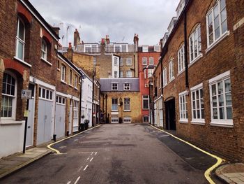 Exterior of residential buildings against cloudy sky