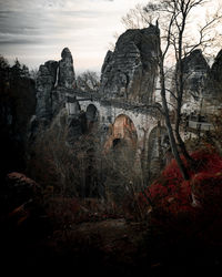 View of arch bridge against cloudy sky