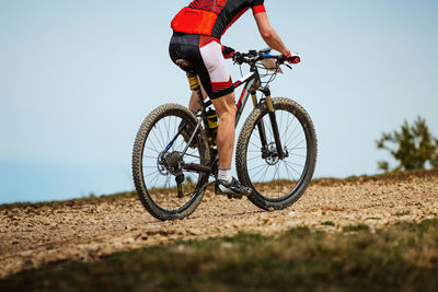 Man riding bicycle on field