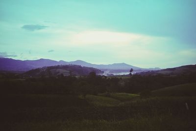 Scenic view of mountains against cloudy sky
